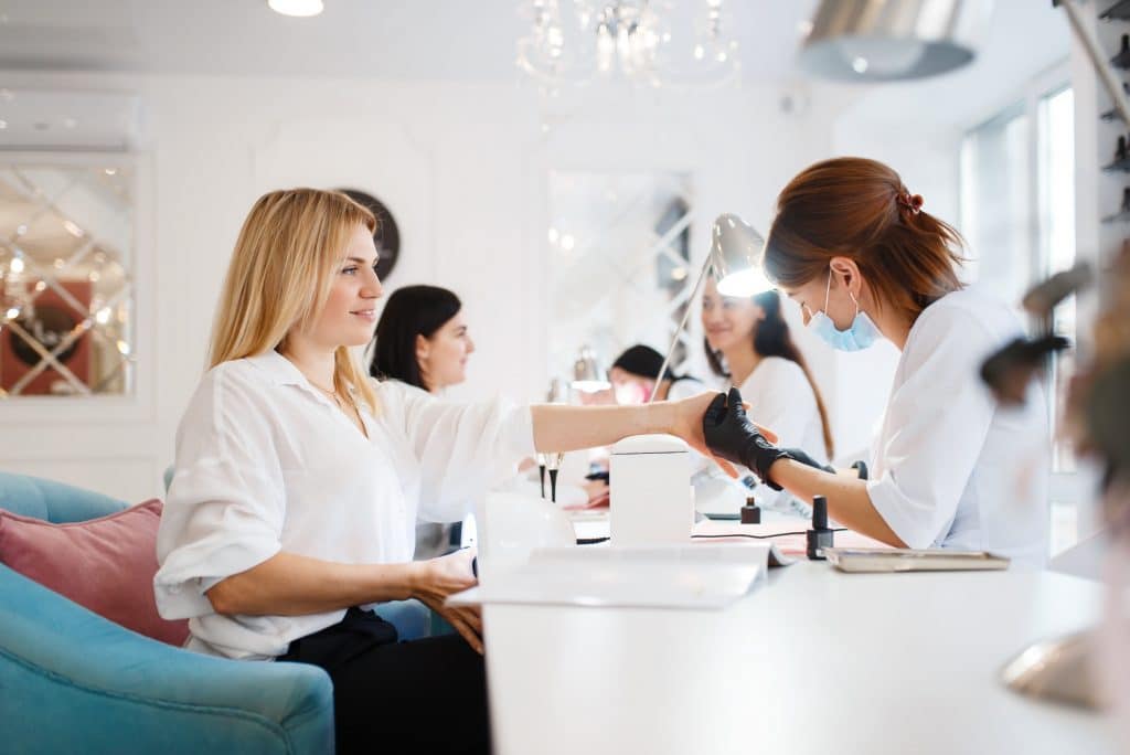 Group of girlfriends, manicure in beauty salon