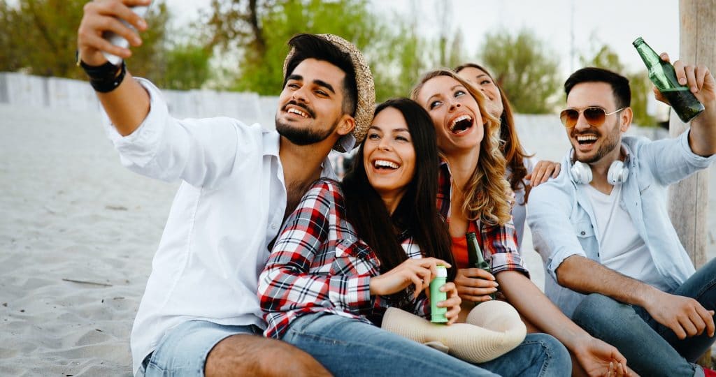 Happy young people taking selfies