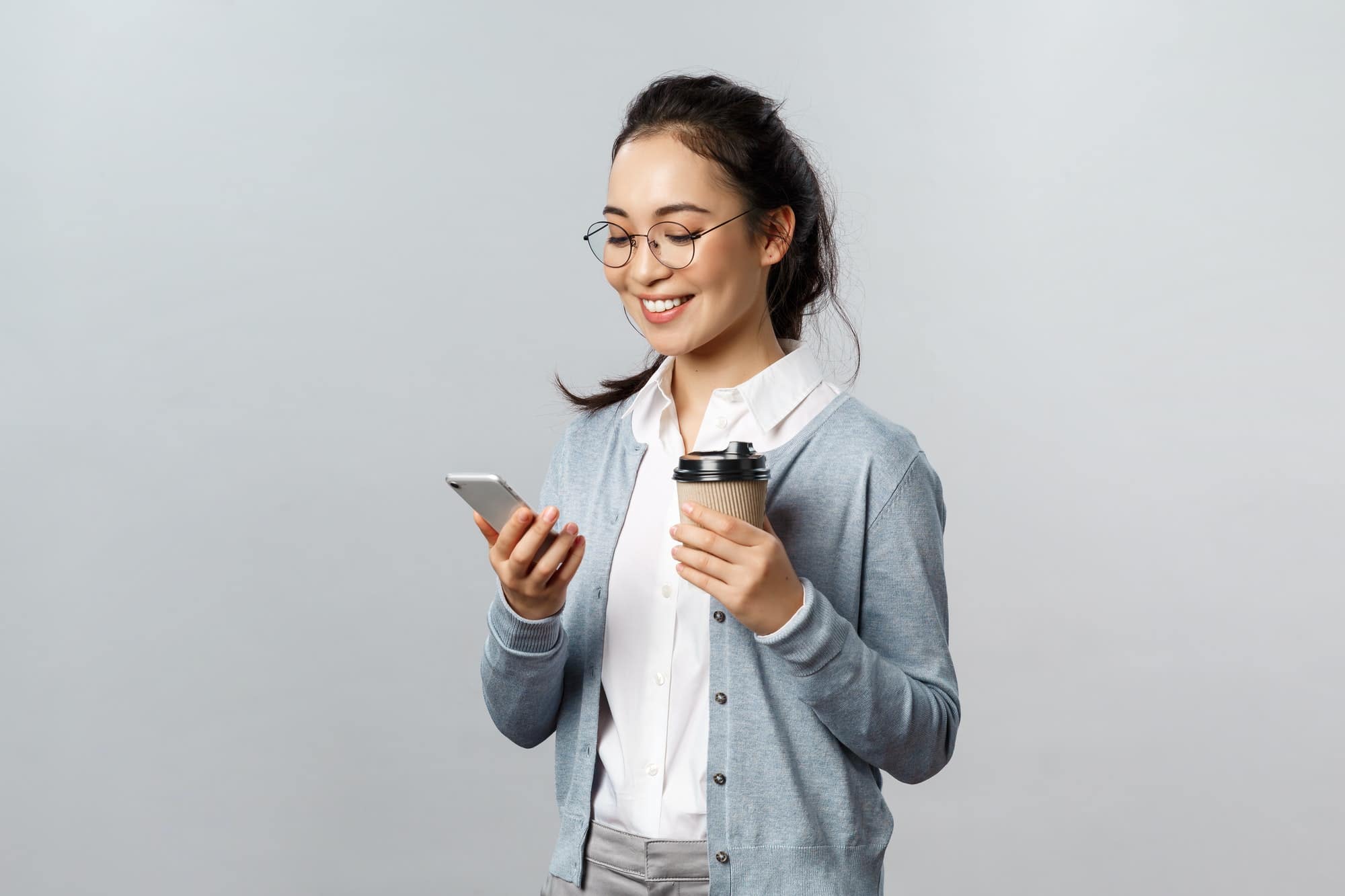 Office lifestyle, business and people concept. Attractive young korean woman checking her phone