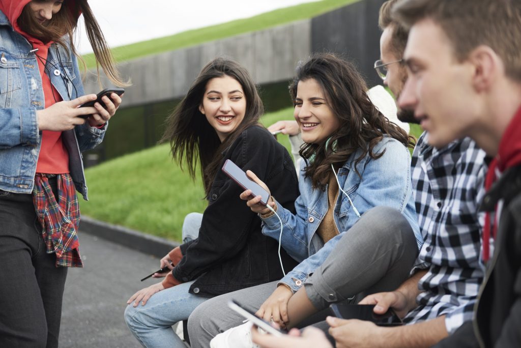 Young people with mobile phone in the city