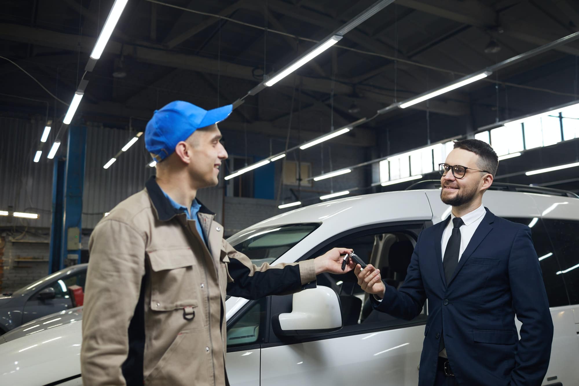 Client Giving Car Keys To Repairman