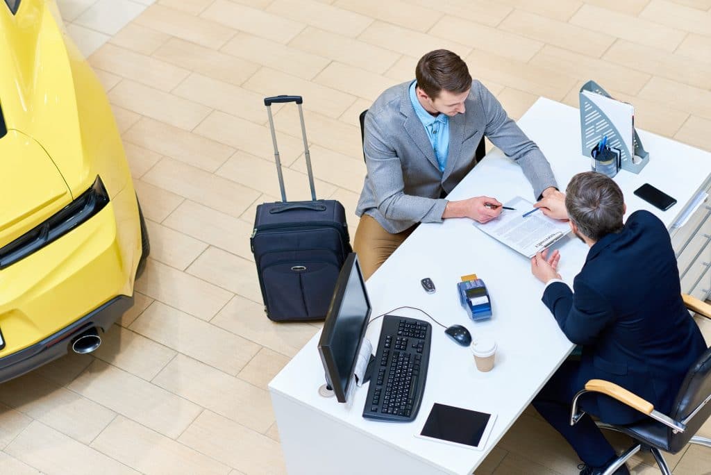 Businessman Signing Car Lease Agreement