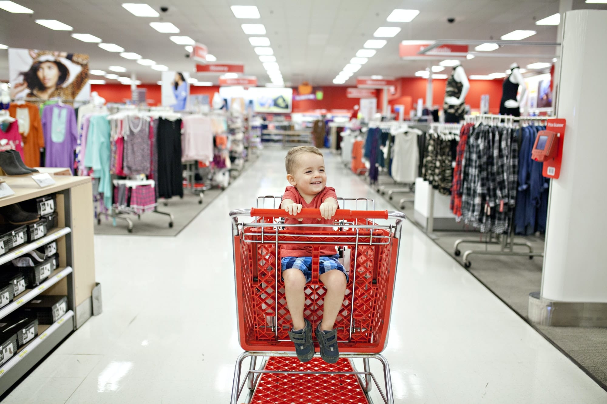 Little boy in target shopping cart at the store.