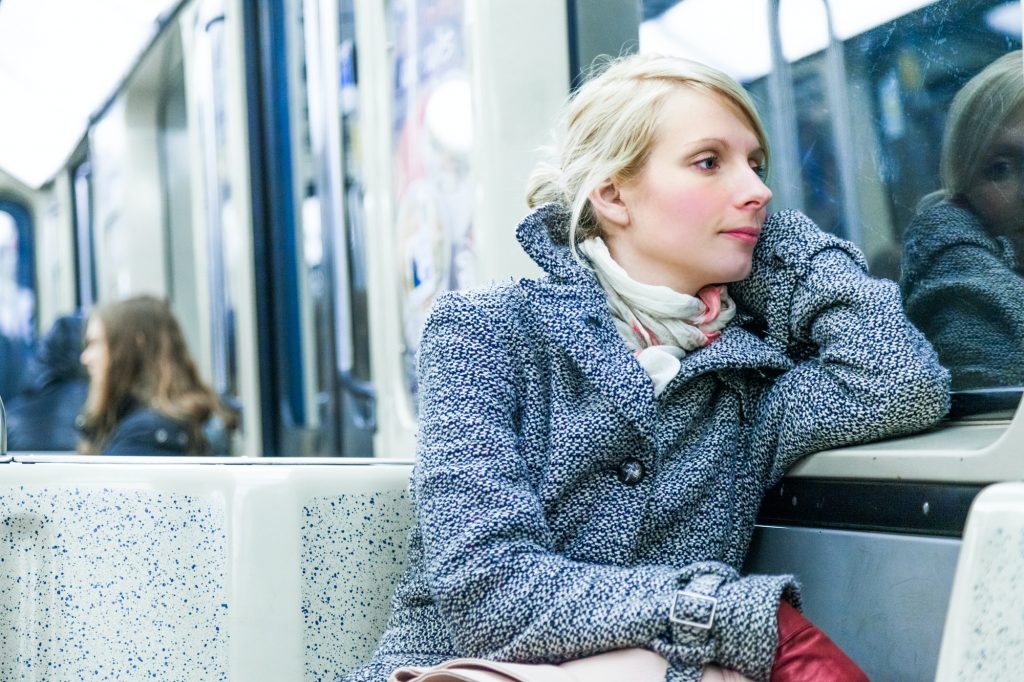 Young Woman Sitting inside a Metro Wagon