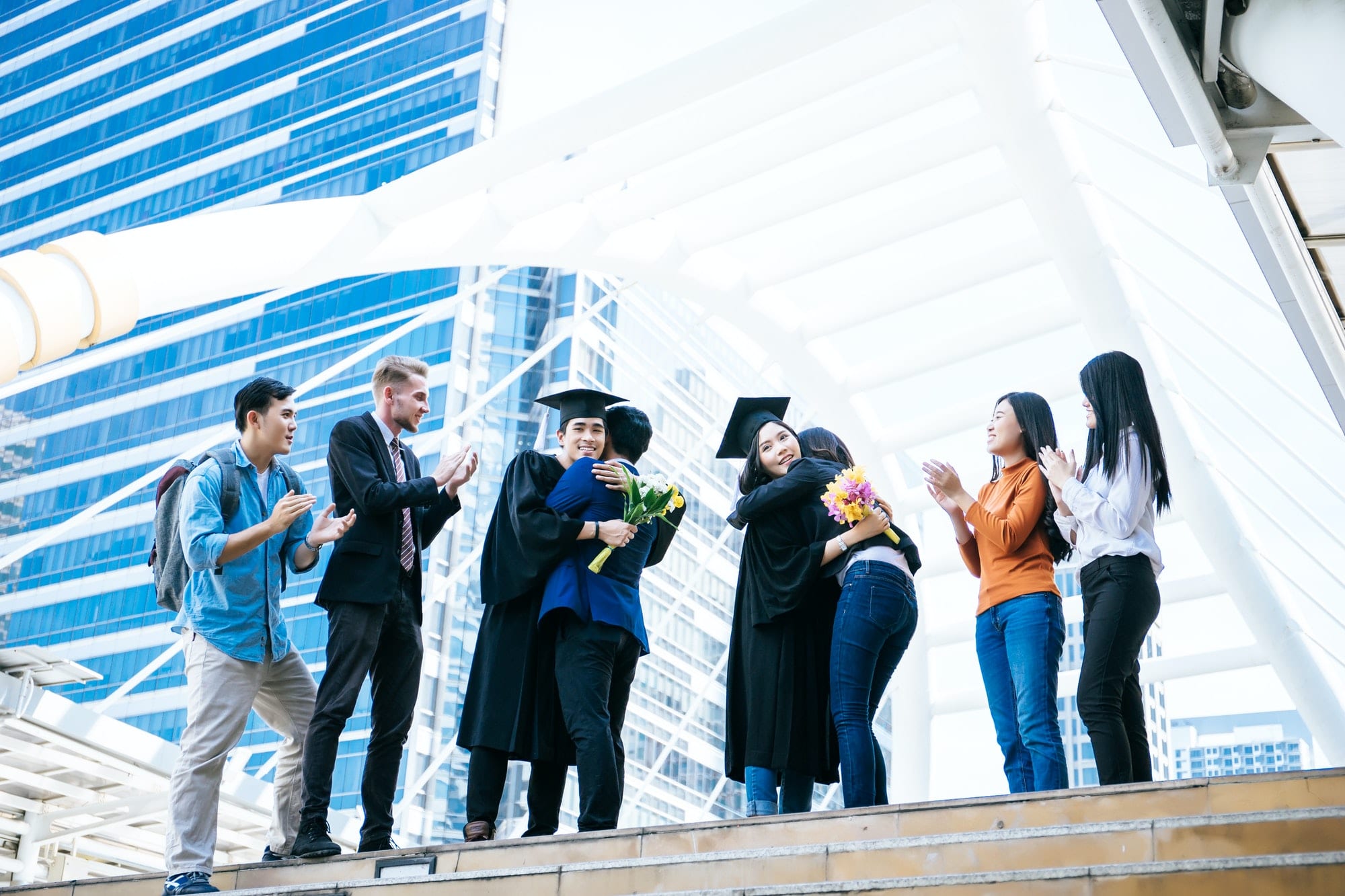 Asian students graduate being congratulated by their parent at graduation ceremony