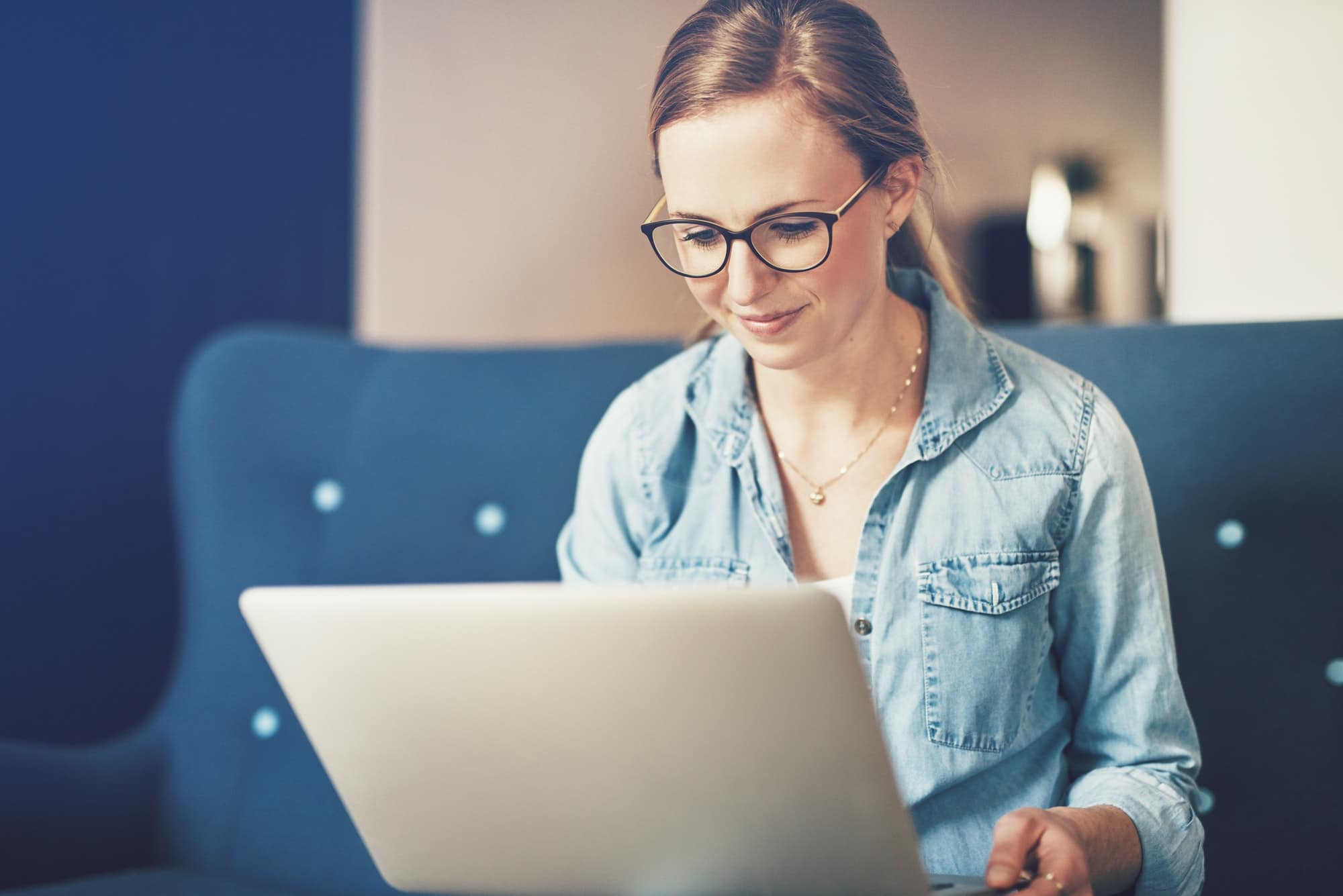 Smiling young businesswoman working online with a laptop