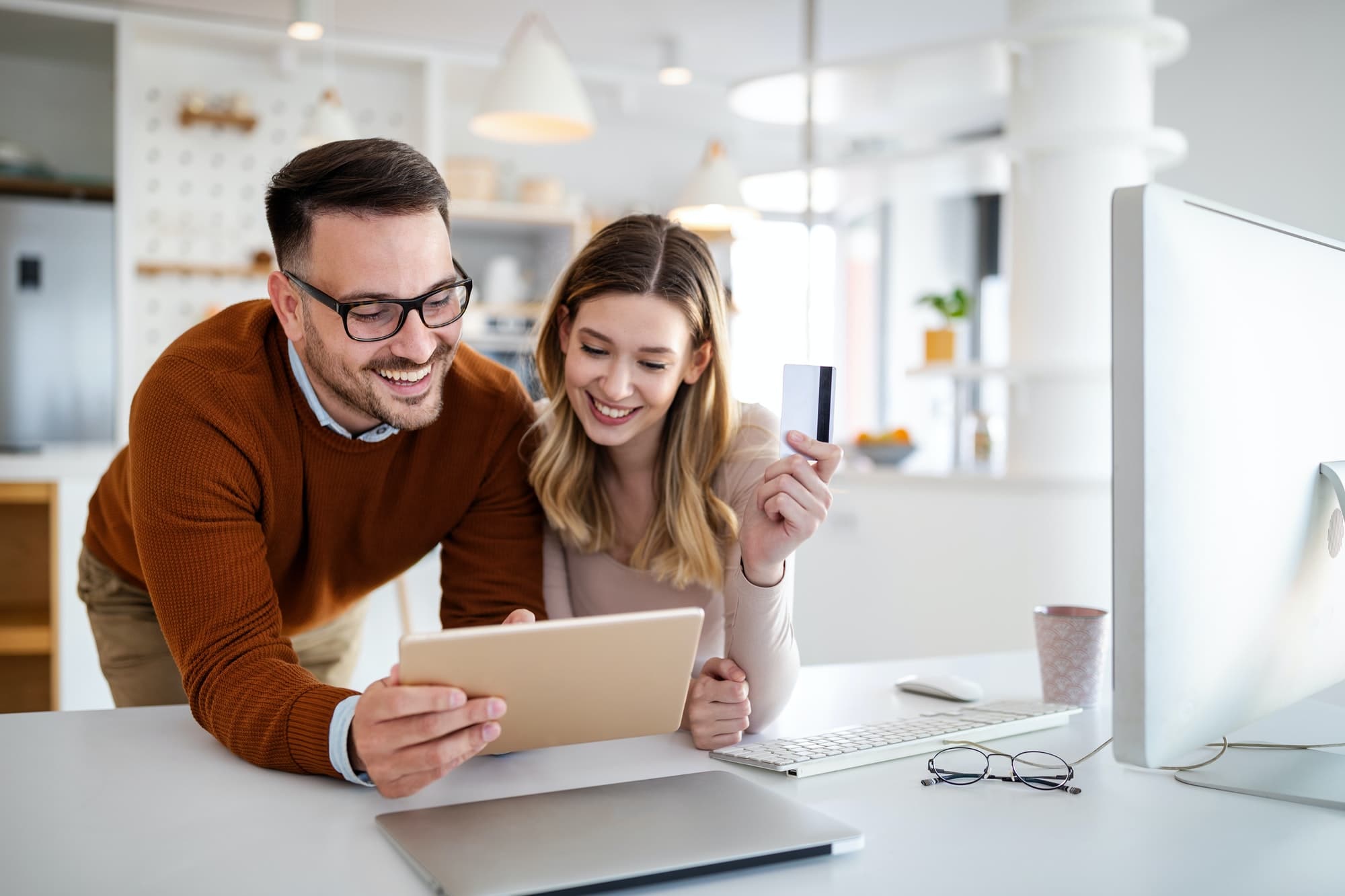 Portrait of a cheerful couple shopping online. Technology, e-commerce, banking concept