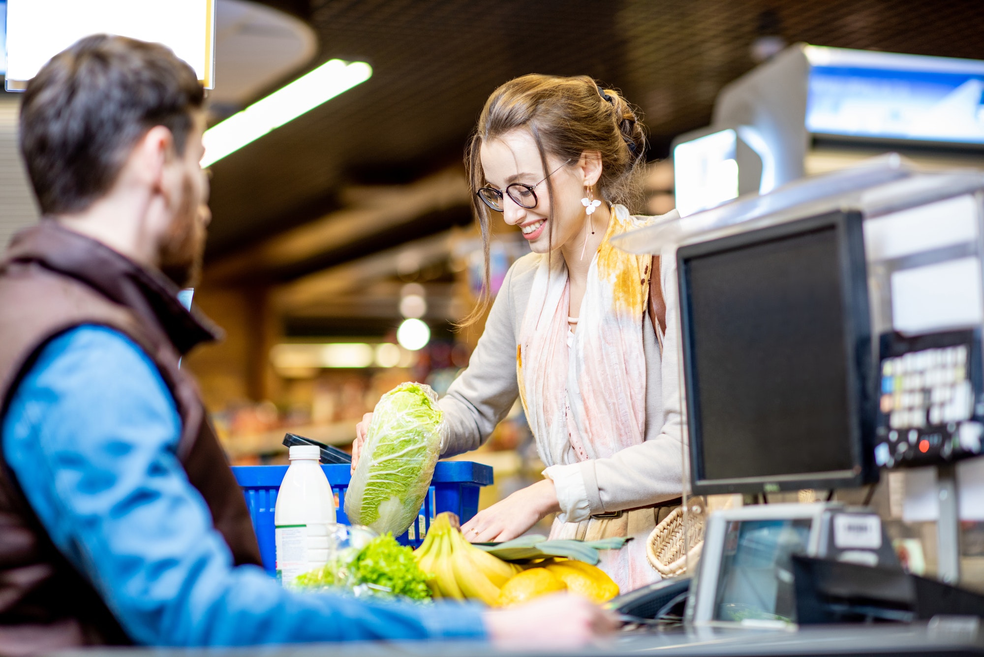 Woman on the cash register with cashier in the supermarket