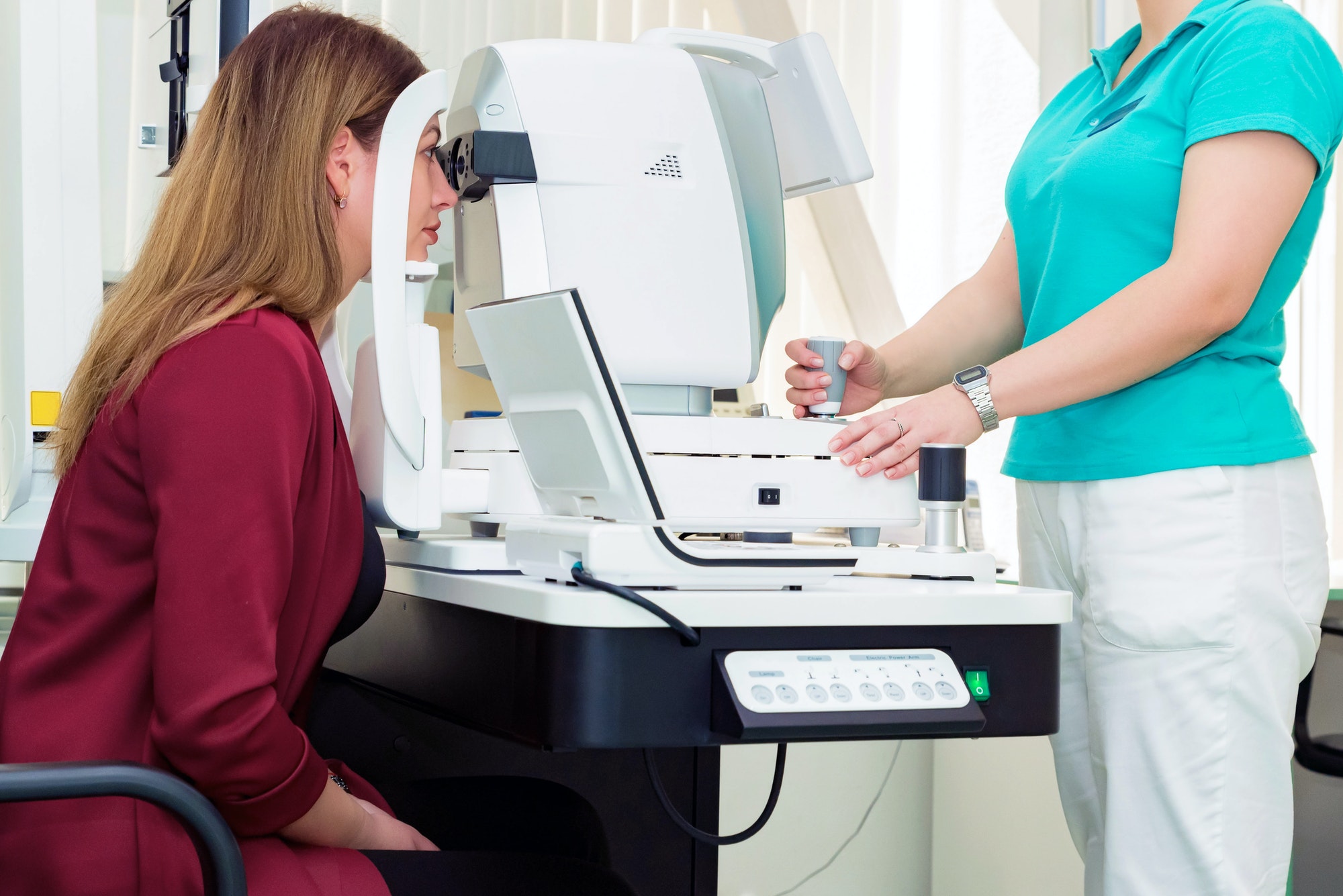 Beautiful woman having an eye lens exam