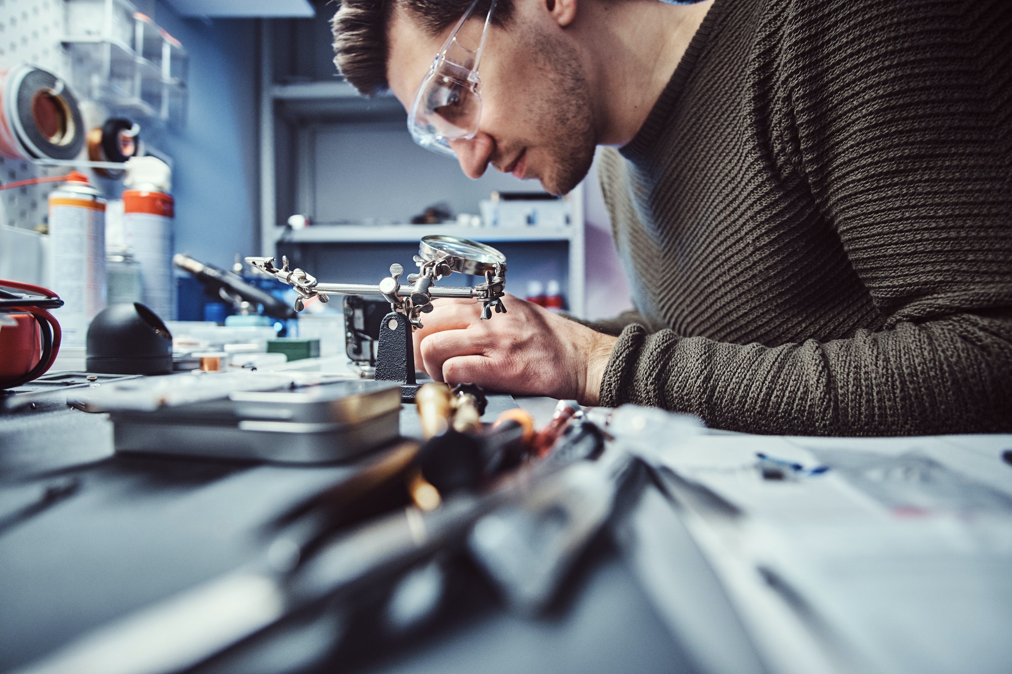 Electronic technician repair damaged smartphone in the workshop