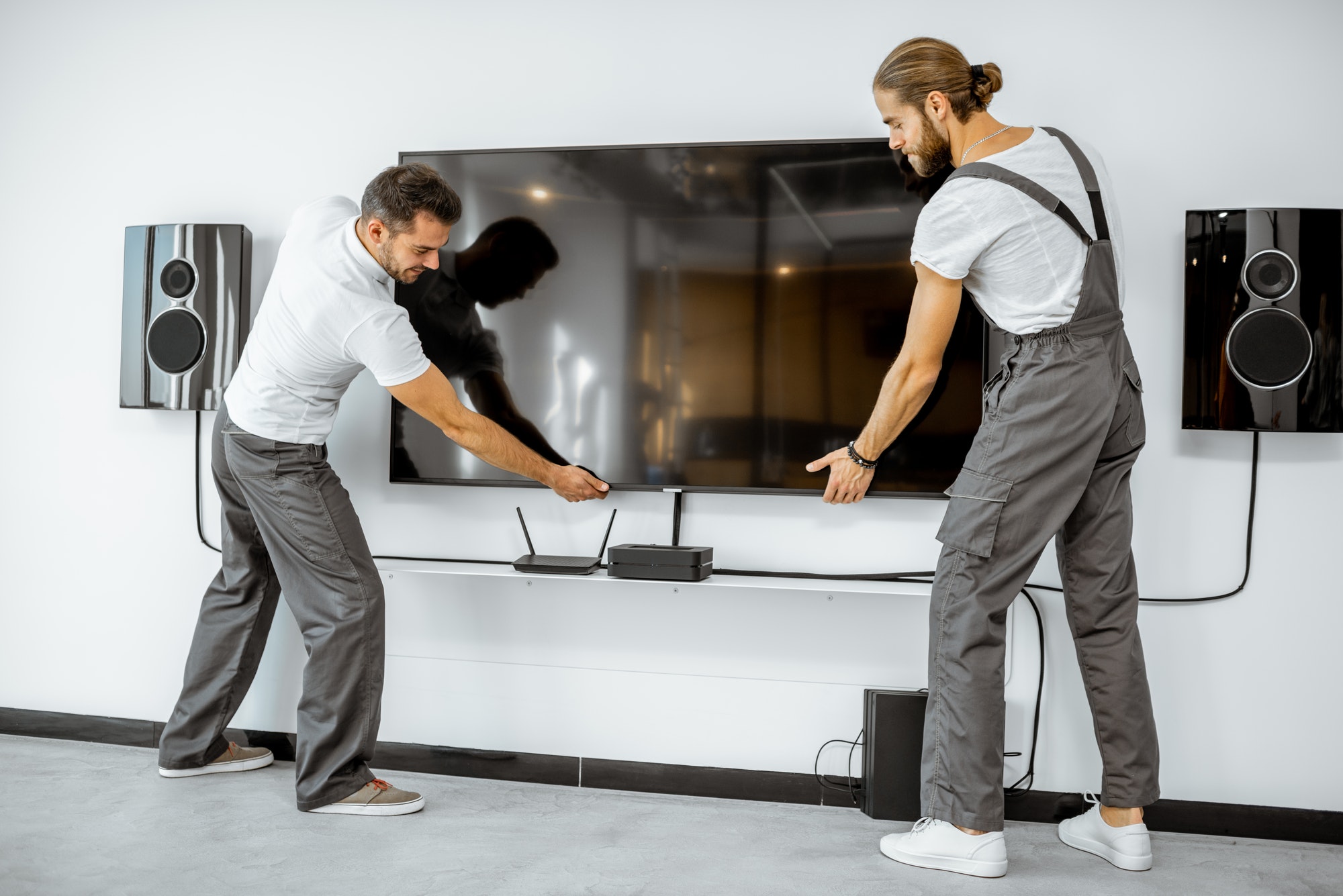 Workmen installing television at home