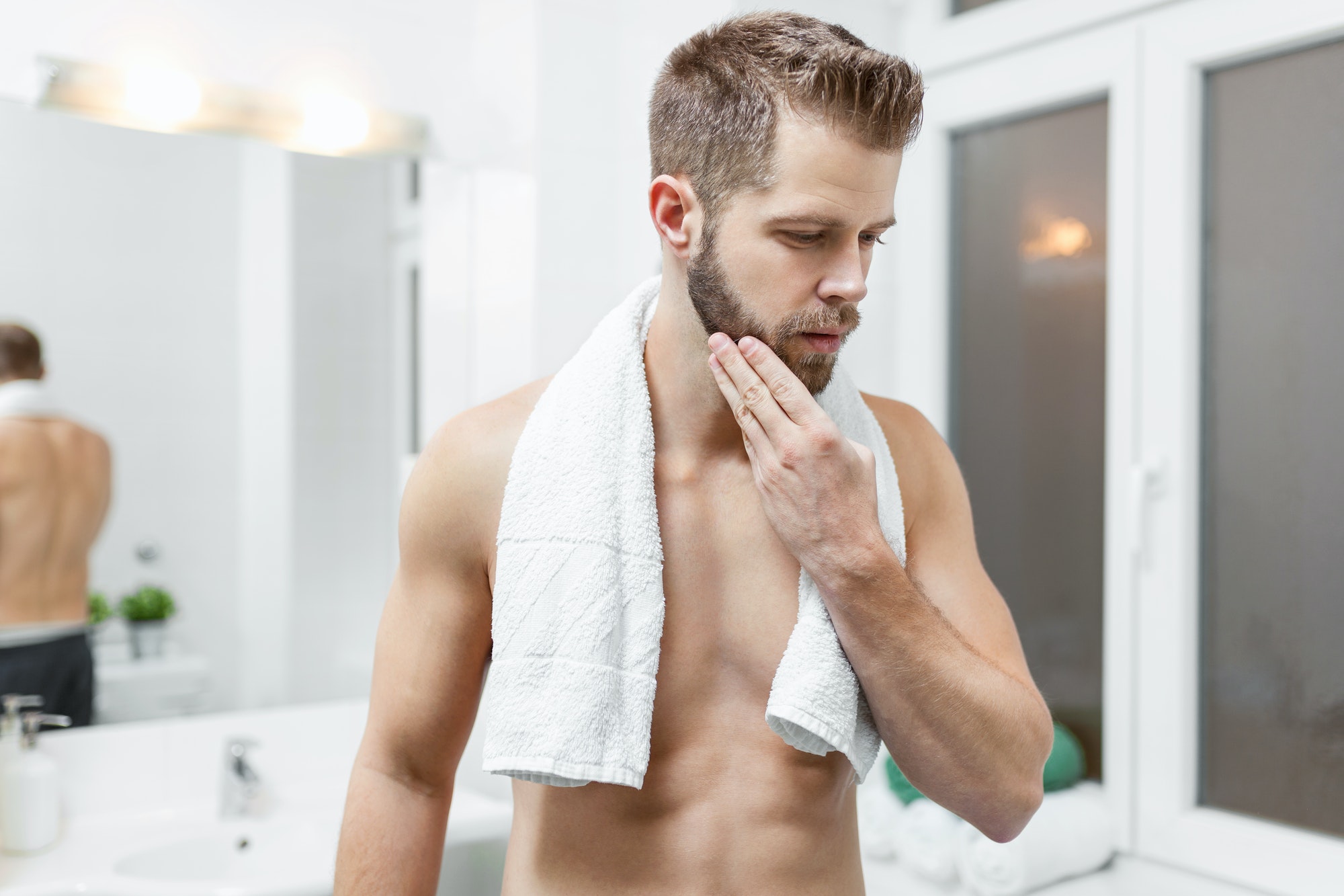 Morning hygiene, Man in the bathroom looking in mirror