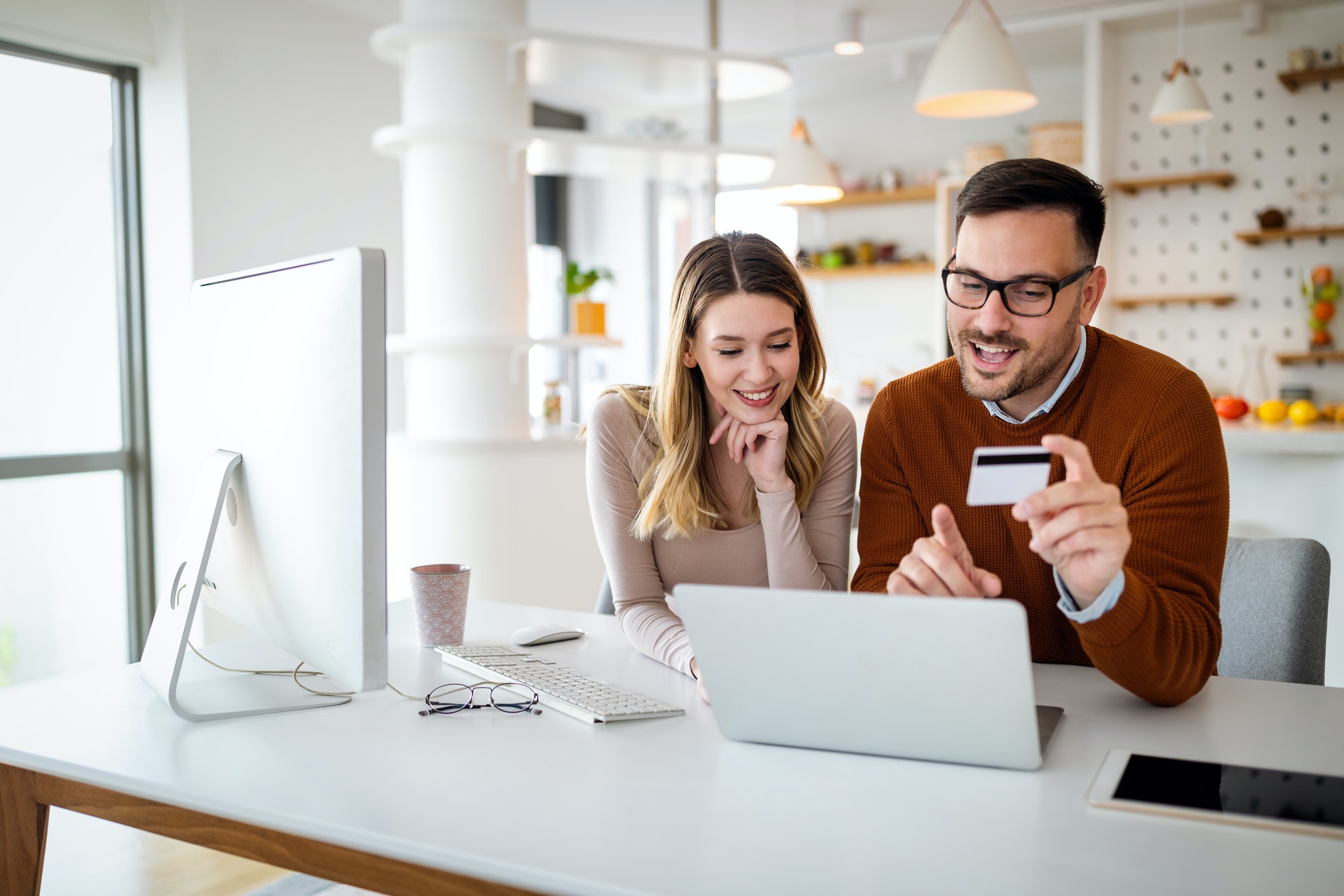 Portrait of a cheerful couple shopping online. Technology, e-commerce, banking concept