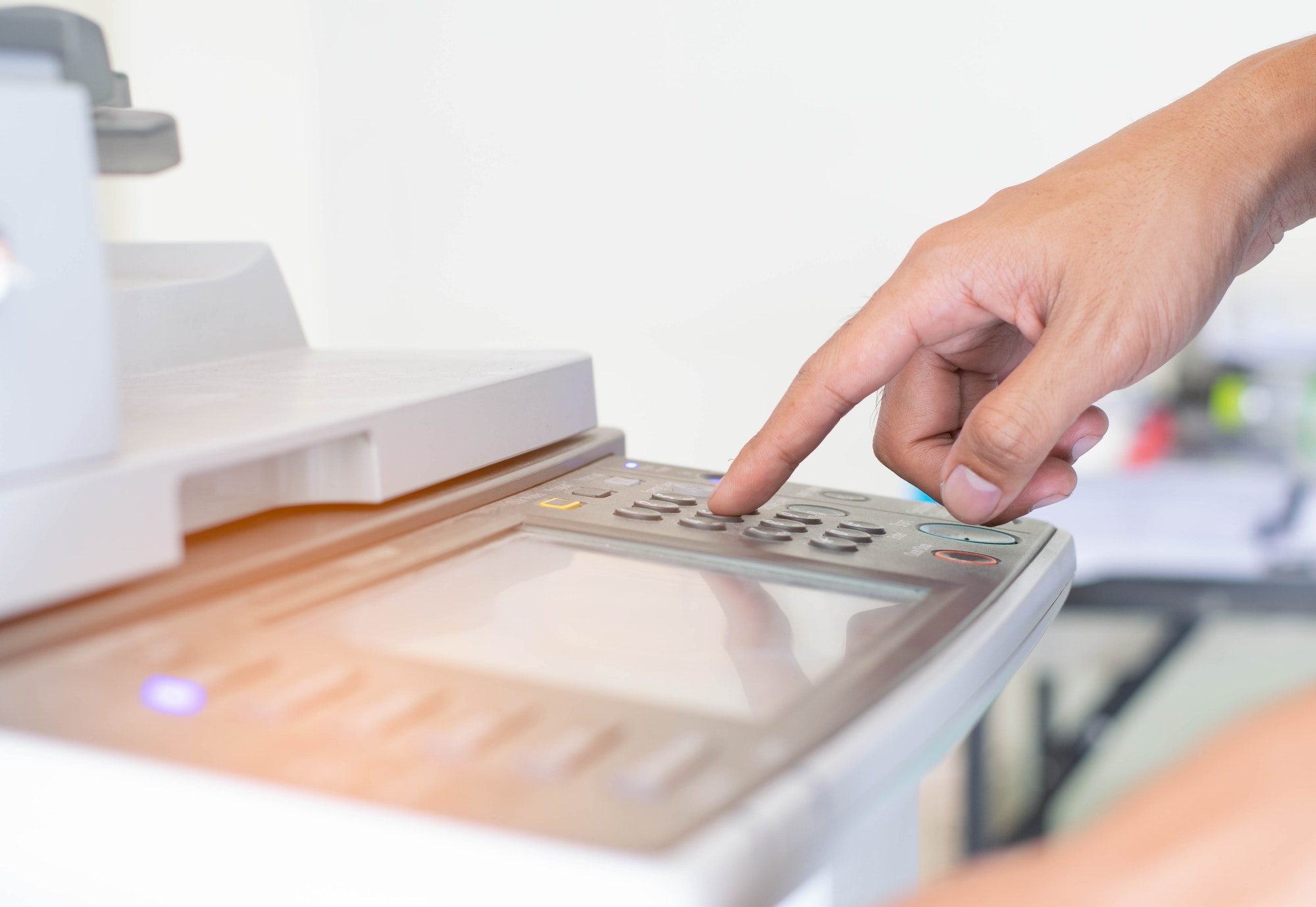 a man is pressing the botton of printer