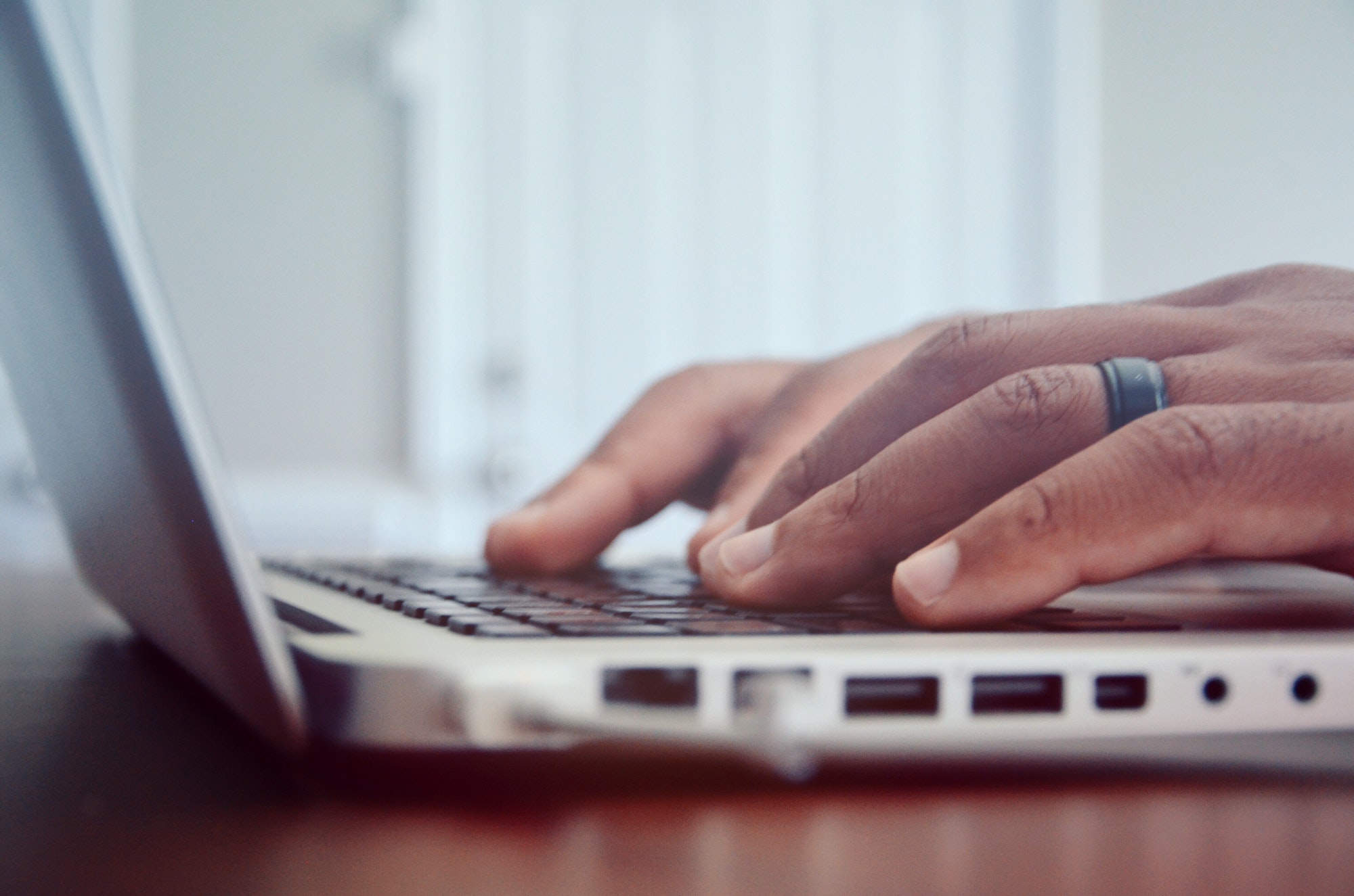 Man's hands on MacBook Pro keyboard